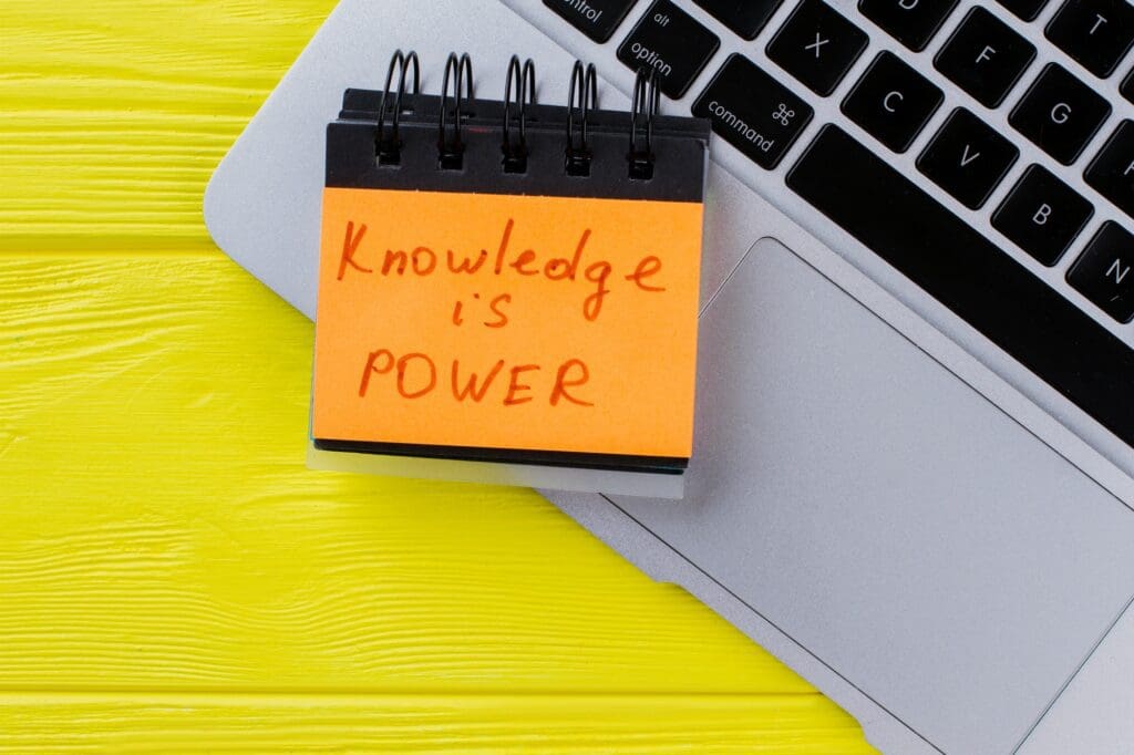 Top view laptop and knowledge is power slogan.